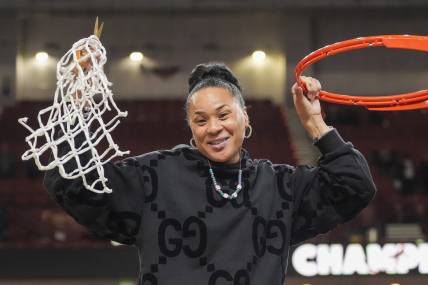 Mar 10, 2024; Greensville, SC, USA;  South Carolina Gamecocks head coach Dawn Staley cuts the net after winning the SEC championship over LSU Lady Tigers at Bon Secours Wellness Arena. Mandatory Credit: Jim Dedmon-USA TODAY Sports