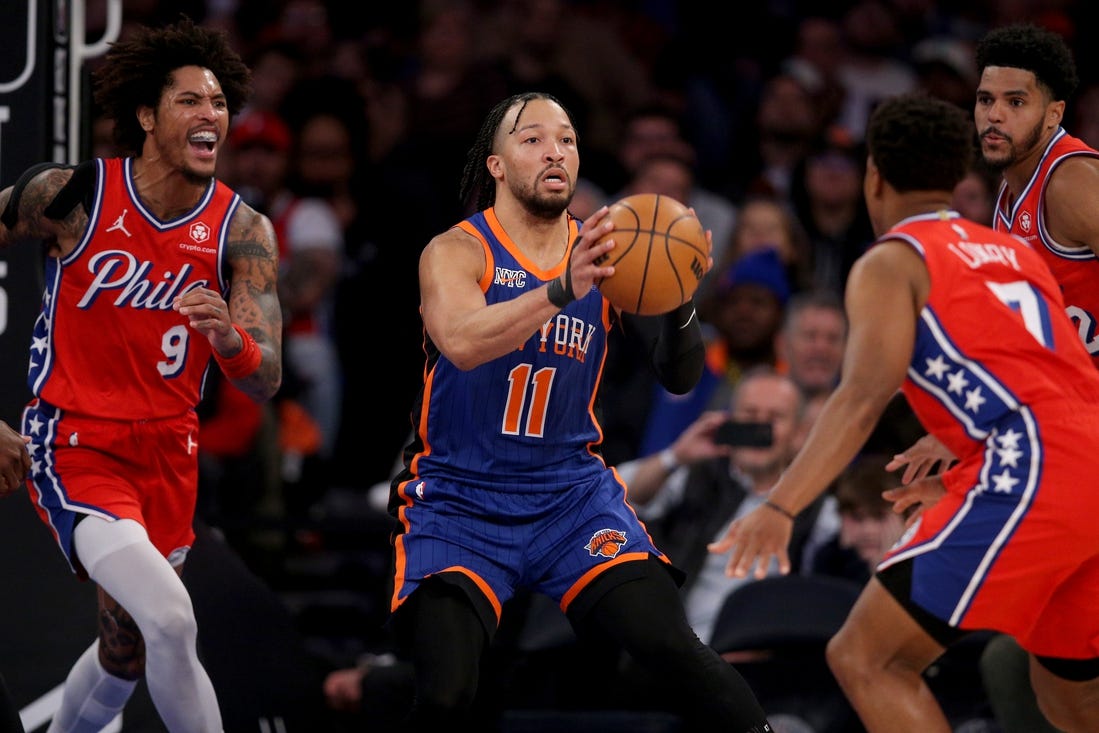 Mar 10, 2024; New York, New York, USA; New York Knicks guard Jalen Brunson (11) looks to pass the ball against Philadelphia 76ers guard Kelly Oubre Jr. (9) and forward Tobias Harris (12) and guard Kyle Lowry (7) during the second quarter at Madison Square Garden. Mandatory Credit: Brad Penner-USA TODAY Sports