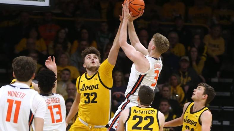 Iowa   s Owen Freeman (32) blocks Illinois    Marcus Domask (3) Sunday, March 10, 2024 at Carver-Hawkeye Arena in Iowa City, Iowa.