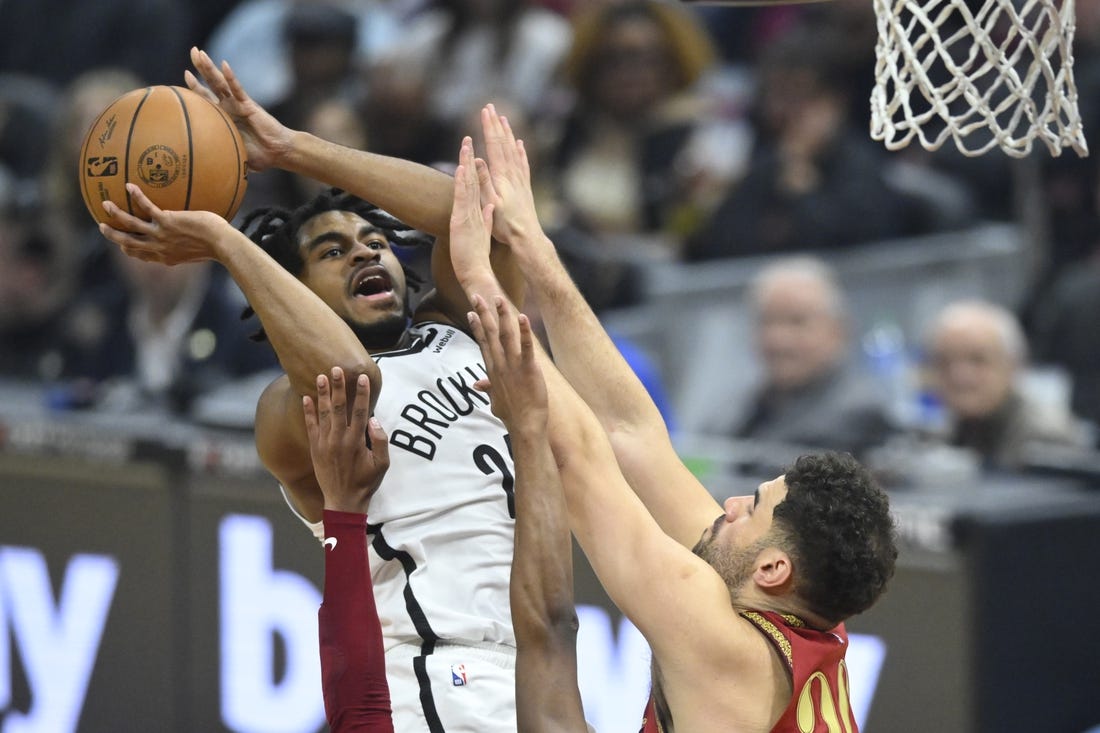 Mar 10, 2024; Cleveland, Ohio, USA; Brooklyn Nets guard Cam Thomas (24) shoots beside Cleveland Cavaliers forward Georges Niang (20) in the first quarter at Rocket Mortgage FieldHouse. Mandatory Credit: David Richard-USA TODAY Sports