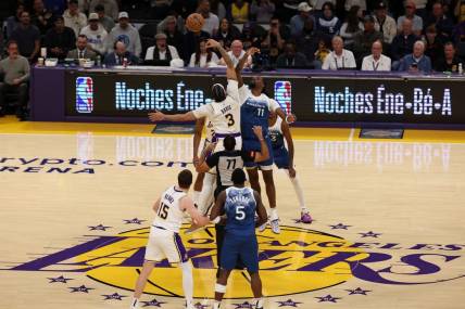 Mar 10, 2024; Los Angeles, California, USA;  Los Angeles Lakers forward Anthony Davis (3) and Minnesota Timberwolves center Naz Reid (11) tip off during the first quarter at Crypto.com Arena. Mandatory Credit: Kiyoshi Mio-USA TODAY Sports
