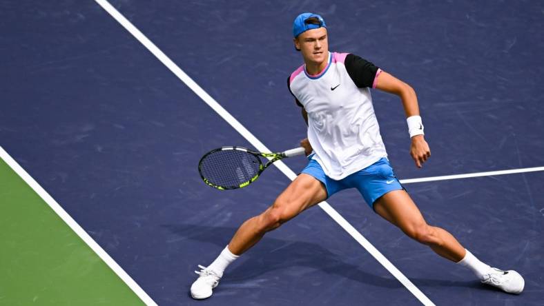 Mar 11, 2024; Indian Wells, CA, USA; Holger Rune (DEN) hits a shot in his third round match against Lorenzo Musetti (ITA) during the BNP Paribas Open at Indian Wells Tennis Garden. Mandatory Credit: Jonathan Hui-USA TODAY Sports