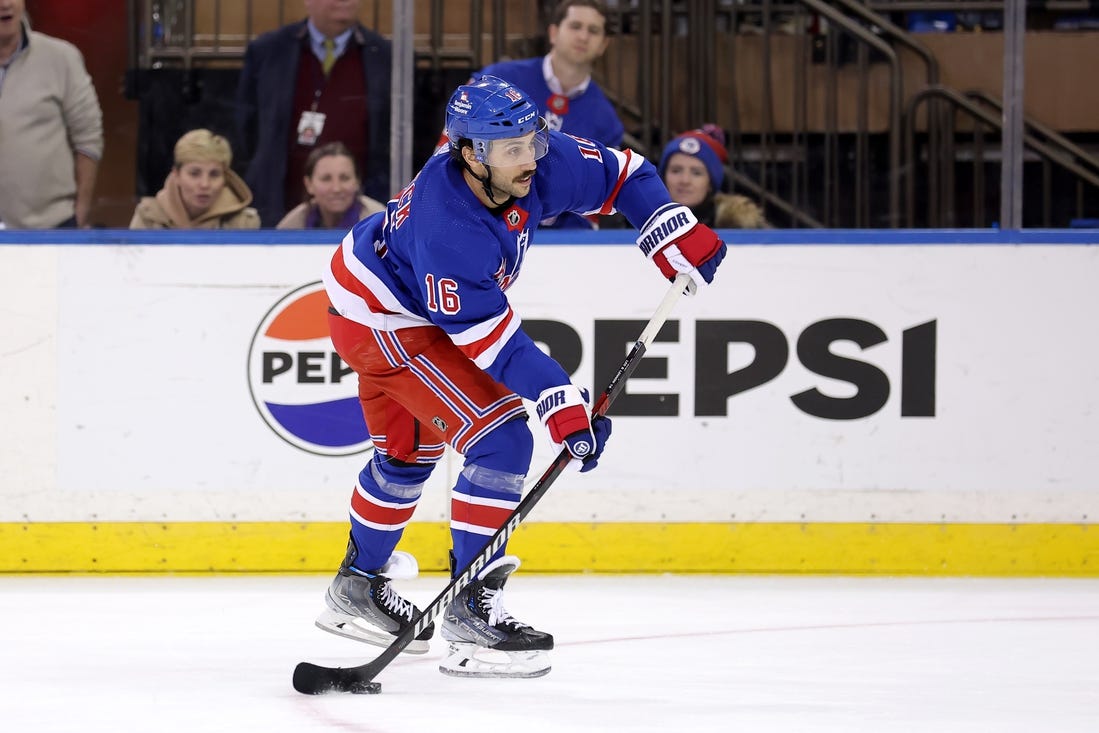 Mar 11, 2024; New York, New York, USA; New York Rangers center Vincent Trocheck (16) shoots and scores an empty net goal against the New Jersey Devils during the third period at Madison Square Garden. Mandatory Credit: Brad Penner-USA TODAY Sports