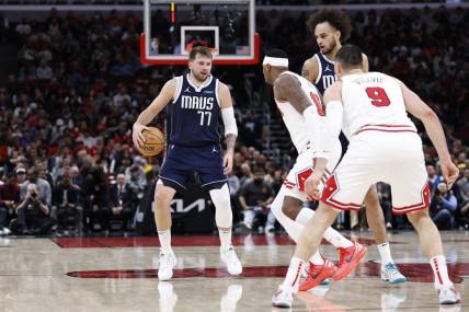 Mar 11, 2024; Chicago, Illinois, USA; Dallas Mavericks guard Luka Doncic (77) brings the ball up court against the Chicago Bulls during the second half at United Center. Mandatory Credit: Kamil Krzaczynski-USA TODAY Sports
