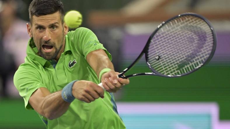 Mar 11, 2024; Indian Wells, CA, USA;  Novak Djokovic (SRB) hits a shot in his third round match against Luca Nardi (ITA) in the BNP Paribas Open at the Indian Wells Tennis Garden. Mandatory Credit: Jayne Kamin-Oncea-USA TODAY Sports