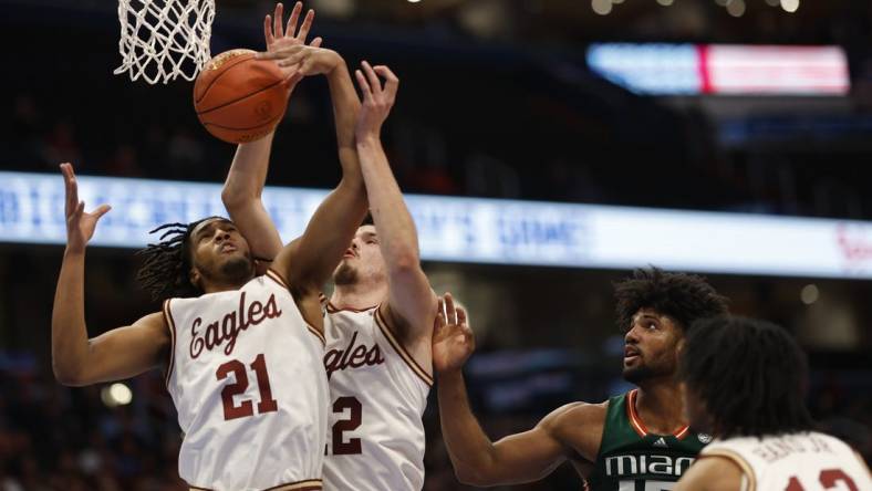 Mar 12, 2024; Washington, D.C., USA; Boston College Eagles forward Devin McGlockton (21) and College Eagles forward Quinten Post (12) reach for a rebound in front of Miami (Fl) Hurricanes forward Norchad Omier (15) in the first half at Capital One Arena. Mandatory Credit: Geoff Burke-USA TODAY Sports