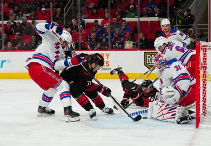 Mar 12, 2024; Raleigh, North Carolina, USA; Carolina Hurricanes right wing Jesper Fast (71) shot attempt is stopped by New York Rangers defenseman Erik Gustafsson (56) and goaltender Igor Shesterkin (31) during the first period at PNC Arena. Mandatory Credit: James Guillory-USA TODAY Sports