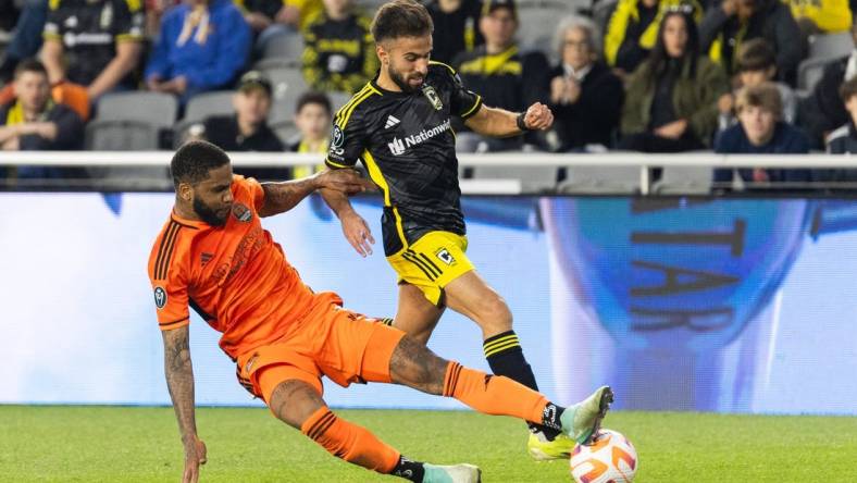 Mar 12, 2024; Columbus, OH, USA; Columbus Crew forward Diego Rossi (10) dribbles the ball while Houston Dynamo defender Micael (31) defends in the second half at Lower.Com Field. Mandatory Credit: Trevor Ruszkowski-USA TODAY Sports