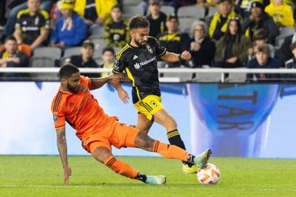 Mar 12, 2024; Columbus, OH, USA; Columbus Crew forward Diego Rossi (10) dribbles the ball while Houston Dynamo defender Micael (31) defends in the second half at Lower.Com Field. Mandatory Credit: Trevor Ruszkowski-USA TODAY Sports