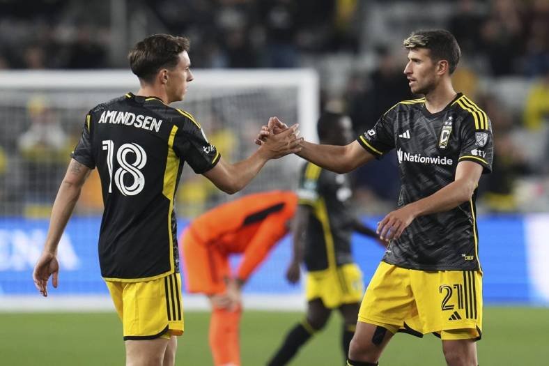 Mar 12, 2024; Columbus, OH, USA;  Columbus Crew defender Malte Amundsen (18) celebrates the win with defender Yevhen Cheberko (21) following the Concacaf Champions Cup soccer game against the Houston Dynamo at Lower.com Field. Mandatory Credit: Adam Cairns-USA TODAY Sports