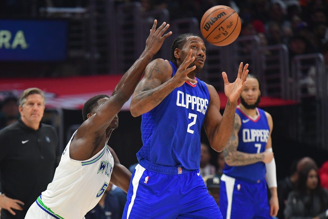 Mar 12, 2024; Los Angeles, California, USA; Los Angeles Clippers forward Kawhi Leonard (2) loses the ball against Minnesota Timberwolves guard Anthony Edwards (5) during the first half at Crypto.com Arena. Mandatory Credit: Gary A. Vasquez-USA TODAY Sports