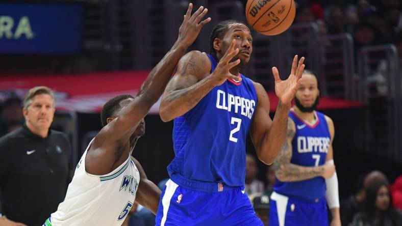 Mar 12, 2024; Los Angeles, California, USA; Los Angeles Clippers forward Kawhi Leonard (2) loses the ball against Minnesota Timberwolves guard Anthony Edwards (5) during the first half at Crypto.com Arena. Mandatory Credit: Gary A. Vasquez-USA TODAY Sports