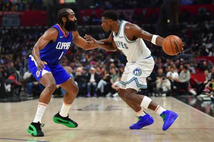 Mar 12, 2024; Los Angeles, California, USA; Minnesota Timberwolves guard Anthony Edwards (5) controls the ball against Los Angeles Clippers guard James Harden (1) during the first half at Crypto.com Arena. Mandatory Credit: Gary A. Vasquez-USA TODAY Sports