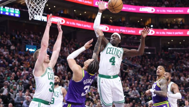 Mar 12, 2024; Salt Lake City, Utah, USA; Utah Jazz guard Keyonte George (3) drives into Boston Celtics forward Sam Hauser (30) and has the shot blocked by guard Jrue Holiday (4) during the fourth quarter at Delta Center. Mandatory Credit: Rob Gray-USA TODAY Sports