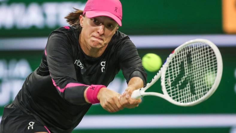 Iga Swiatek hits a shot in her win over Yulia Putintseva during the BNP Paribas Open in Indian Wells, Calif., March 12, 2024.