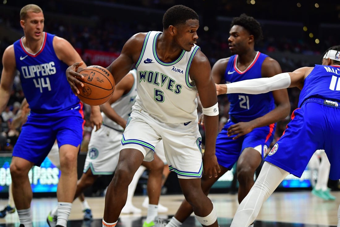 Mar 12, 2024; Los Angeles, California, USA; Minnesota Timberwolves guard Anthony Edwards (5) controls the ball against the Los Angeles Clippers during the second half at Crypto.com Arena. Mandatory Credit: Gary A. Vasquez-USA TODAY Sports