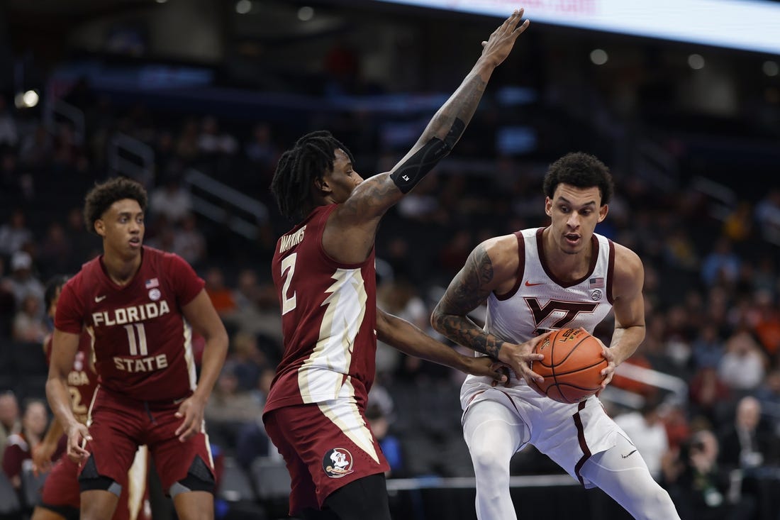 Mar 13, 2024; Washington, D.C., USA; Virginia Tech Hokies center Lynn Kidd (15) drives to the basket as Florida State Seminoles forward Jamir Watkins (2) defends in the first half at Capital One Arena. Mandatory Credit: Geoff Burke-USA TODAY Sports