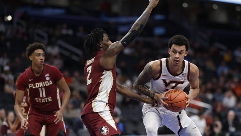 Mar 13, 2024; Washington, D.C., USA; Virginia Tech Hokies center Lynn Kidd (15) drives to the basket as Florida State Seminoles forward Jamir Watkins (2) defends in the first half at Capital One Arena. Mandatory Credit: Geoff Burke-USA TODAY Sports