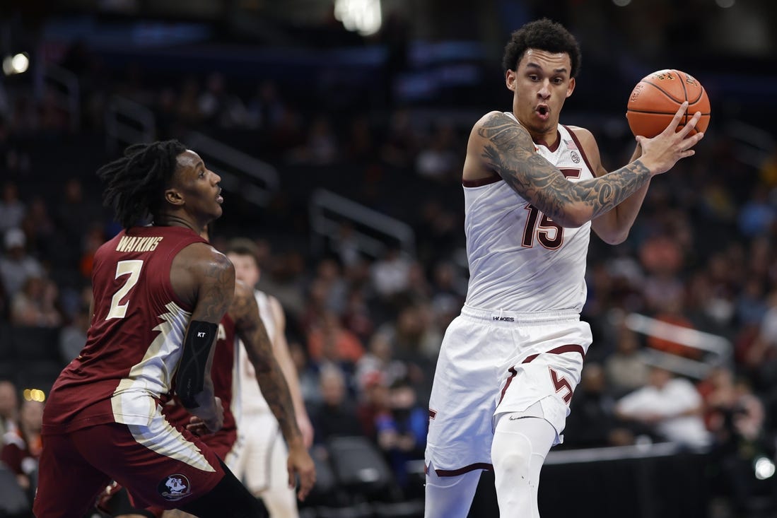 Mar 13, 2024; Washington, D.C., USA; Virginia Tech Hokies center Lynn Kidd (15) drives to the basket as Florida State Seminoles forward Jamir Watkins (2) defends in the first half at Capital One Arena. Mandatory Credit: Geoff Burke-USA TODAY Sports