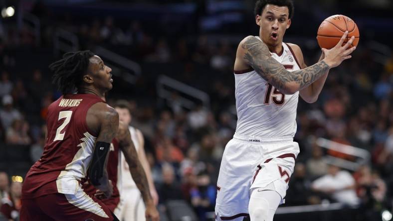 Mar 13, 2024; Washington, D.C., USA; Virginia Tech Hokies center Lynn Kidd (15) drives to the basket as Florida State Seminoles forward Jamir Watkins (2) defends in the first half at Capital One Arena. Mandatory Credit: Geoff Burke-USA TODAY Sports