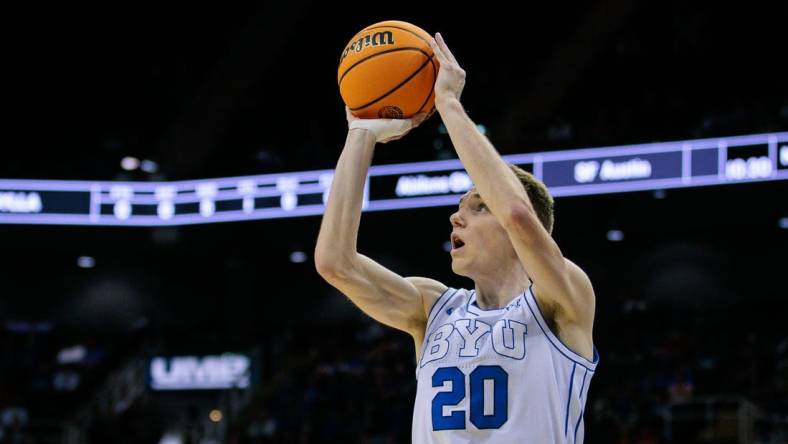 Mar 13, 2024; Kansas City, MO, USA; Brigham Young Cougars guard Spencer Johnson (20) shoots the ball during the first half against the UCF Knights at T-Mobile Center. Mandatory Credit: William Purnell-USA TODAY Sports