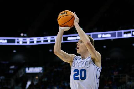 Mar 13, 2024; Kansas City, MO, USA; Brigham Young Cougars guard Spencer Johnson (20) shoots the ball during the first half against the UCF Knights at T-Mobile Center. Mandatory Credit: William Purnell-USA TODAY Sports