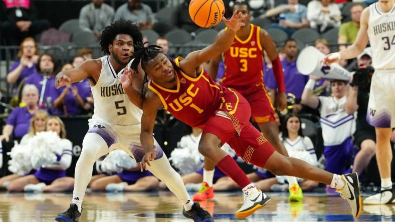 Mar 13, 2024; Las Vegas, NV, USA; USC Trojans guard Isaiah Collier (1) loses control of the ball near Washington Huskies guard Sahvir Wheeler (5) during the first half at T-Mobile Arena. Mandatory Credit: Stephen R. Sylvanie-USA TODAY Sports