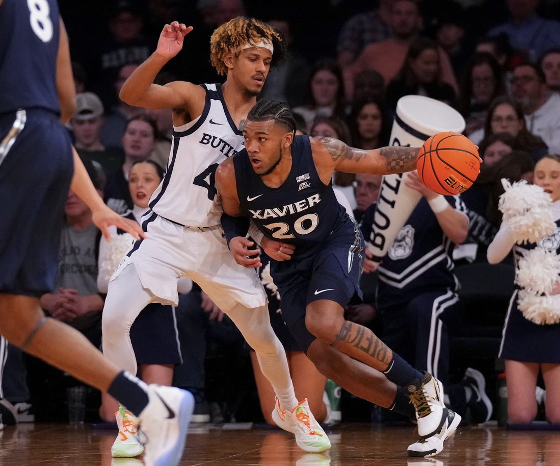 Mar 13, 2024; New York City, NY, USA; Xavier Musketeers guard Dayvion McKnight (20) drives on Butler Bulldogs guard DJ Davis (4) during the first half at Madison Square Garden. Mandatory Credit: Robert Deutsch-USA TODAY Sports