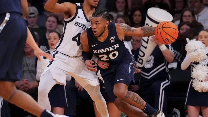 Mar 13, 2024; New York City, NY, USA; Xavier Musketeers guard Dayvion McKnight (20) drives on Butler Bulldogs guard DJ Davis (4) during the first half at Madison Square Garden. Mandatory Credit: Robert Deutsch-USA TODAY Sports