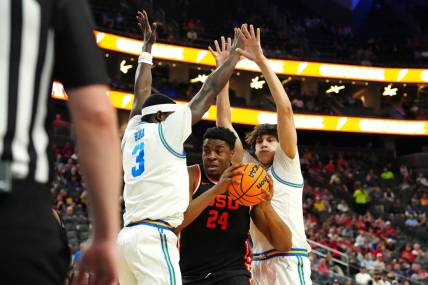 Mar 13, 2024; Las Vegas, NV, USA; Oregon State Beavers center KC Ibekwe (24) looks to shoot between UCLA Bruins forward Adem Bona (3) and UCLA Bruins forward Berke Buyuktuncel (9) during the first half at T-Mobile Arena. Mandatory Credit: Stephen R. Sylvanie-USA TODAY Sports