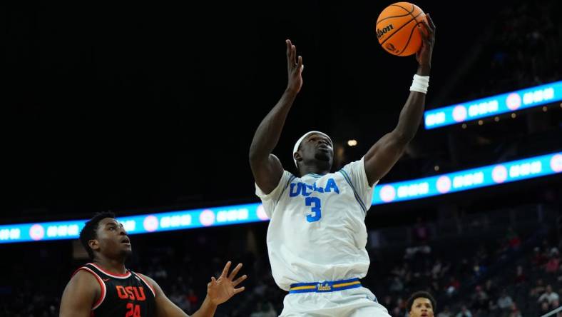 Mar 13, 2024; Las Vegas, NV, USA; UCLA Bruins forward Adem Bona (3) catches the ball against Oregon State Beavers center KC Ibekwe (24) in the first half at T-Mobile Arena. Mandatory Credit: Kirby Lee-USA TODAY Sports