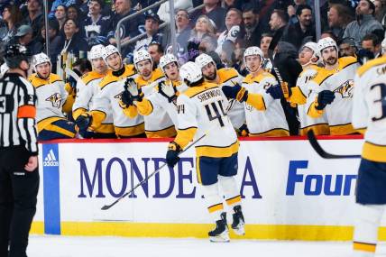 Mar 13, 2024; Winnipeg, Manitoba, CAN; Nashville Predators forward Keifer Sherwood (44) is congratulated by his team mates on his goal against the Winnipeg Jets during the first period at Canada Life Centre. Mandatory Credit: Terrence Lee-USA TODAY Sports