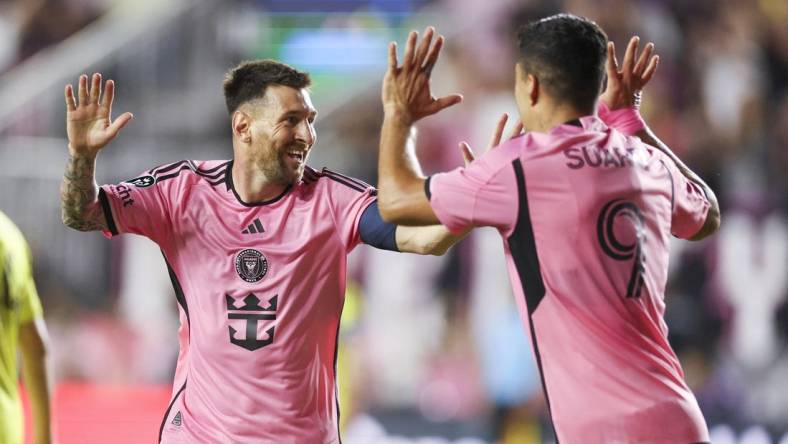 Mar 13, 2024; Fort Lauderdale, FL, USA;  Inter Miami CF forward Lionel Messi (10) celebrates after scoring a goal with forward Luis Suarez (9) against the Nashville SC in the first half during the Concacaf round of sixteen at Chase Stadium. Mandatory Credit: Nathan Ray Seebeck-USA TODAY Sports