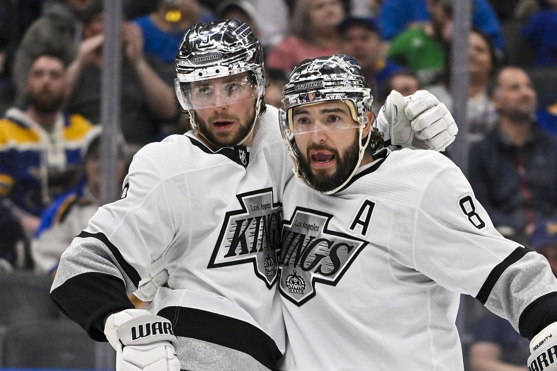 Mar 13, 2024; St. Louis, Missouri, USA;  Los Angeles Kings right wing Adrian Kempe (9) celebrates with defenseman Drew Doughty (8) after scoring against the St. Louis Blues during the third period at Enterprise Center. Mandatory Credit: Jeff Curry-USA TODAY Sports