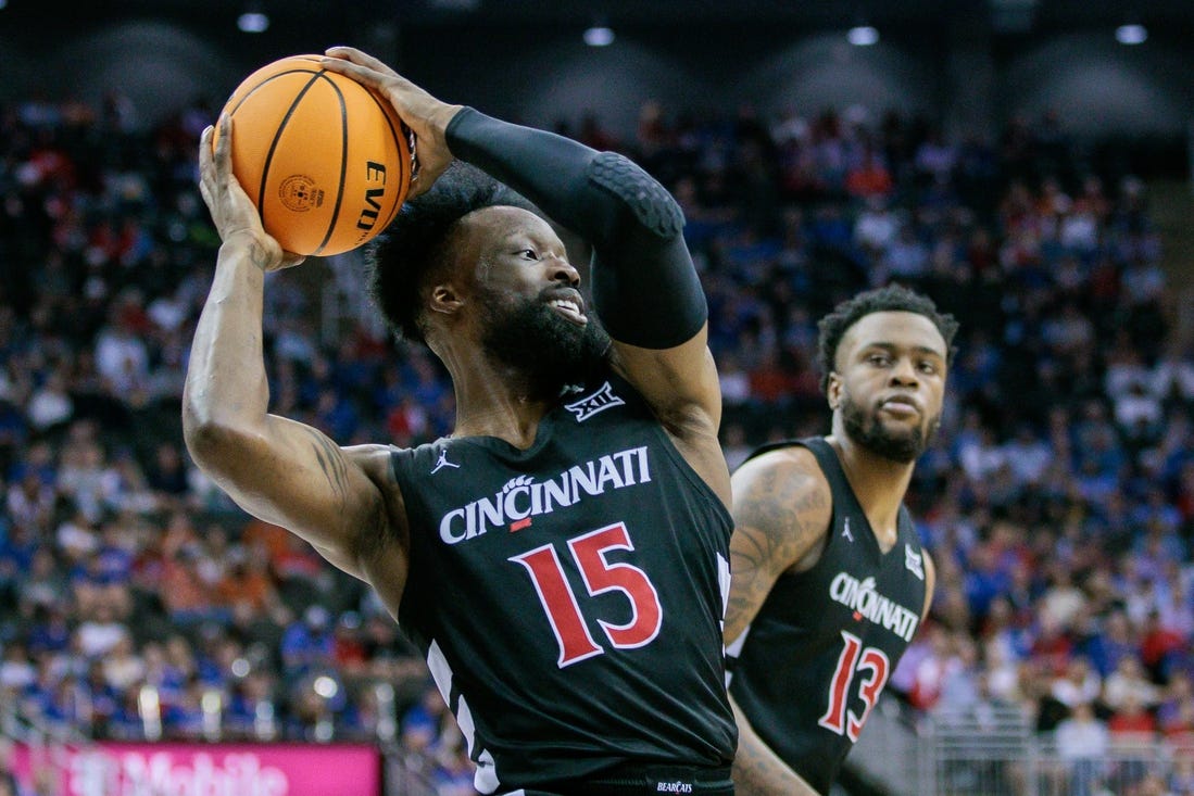 Mar 13, 2024; Kansas City, MO, USA; Cincinnati Bearcats forward John Newman III (15) grabs the rebound during the first half against the Kansas Jayhawks at T-Mobile Center. Mandatory Credit: William Purnell-USA TODAY Sports