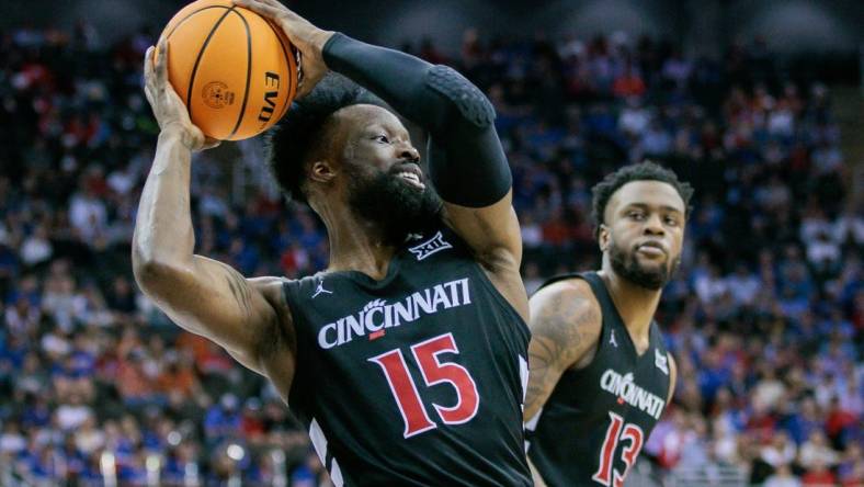 Mar 13, 2024; Kansas City, MO, USA; Cincinnati Bearcats forward John Newman III (15) grabs the rebound during the first half against the Kansas Jayhawks at T-Mobile Center. Mandatory Credit: William Purnell-USA TODAY Sports