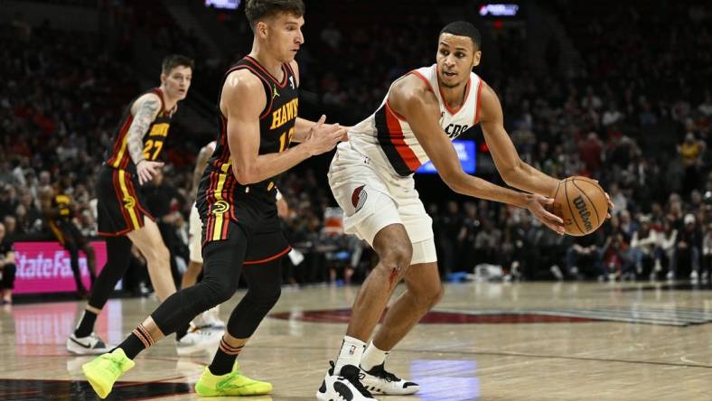 Mar 13, 2024; Portland, Oregon, USA; Portland Trail Blazers forward Kris Murray (8) looks for an opening during the first half against Atlanta Hawks guard Bogdan Bogdanovic (13) at Moda Center. Mandatory Credit: Troy Wayrynen-USA TODAY Sports