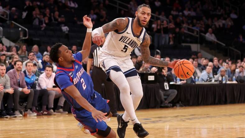 Mar 13, 2024; New York City, NY, USA; Villanova Wildcats guard Justin Moore (5) is fouled by DePaul Blue Demons guard Chico Carter Jr. (2) during the second half at Madison Square Garden. Mandatory Credit: Brad Penner-USA TODAY Sports