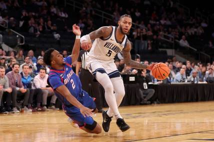 Mar 13, 2024; New York City, NY, USA; Villanova Wildcats guard Justin Moore (5) is fouled by DePaul Blue Demons guard Chico Carter Jr. (2) during the second half at Madison Square Garden. Mandatory Credit: Brad Penner-USA TODAY Sports