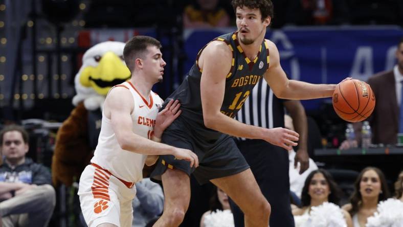 Mar 13, 2024; Washington, D.C., USA; Boston College Eagles forward Quinten Post (12) dribbles the ball as Clemson Tigers guard Joseph Girard III (11) defends in the second half at Capital One Arena. Mandatory Credit: Geoff Burke-USA TODAY Sports