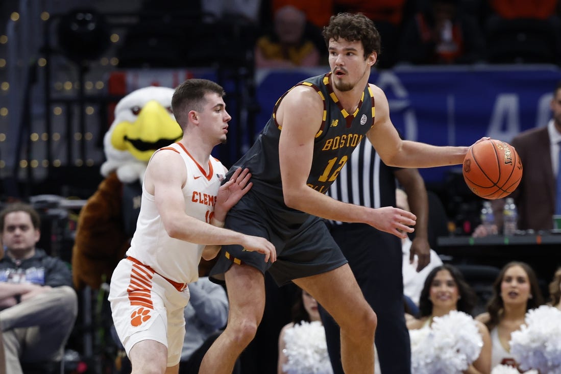 Mar 13, 2024; Washington, D.C., USA; Boston College Eagles forward Quinten Post (12) dribbles the ball as Clemson Tigers guard Joseph Girard III (11) defends in the second half at Capital One Arena. Mandatory Credit: Geoff Burke-USA TODAY Sports