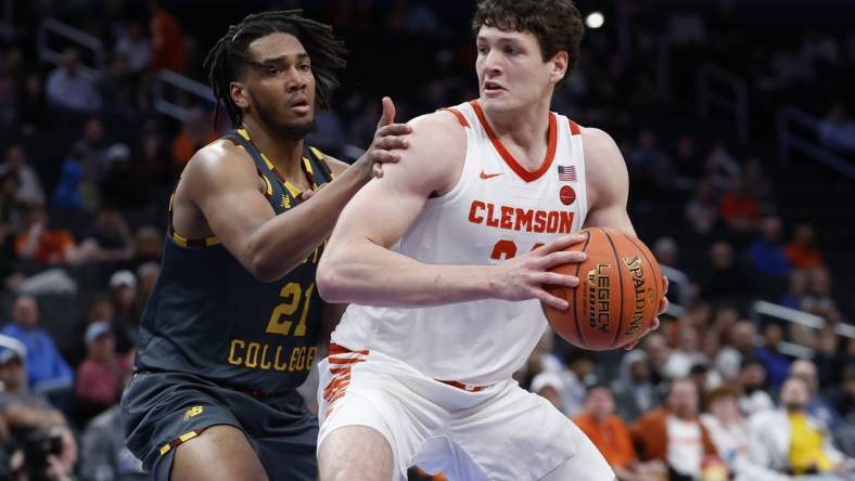 Mar 13, 2024; Washington, D.C., USA; Clemson Tigers center PJ Hall (24) drives to the basket as Boston College Eagles forward Devin McGlockton (21) defends in the second half at Capital One Arena. Mandatory Credit: Geoff Burke-USA TODAY Sports