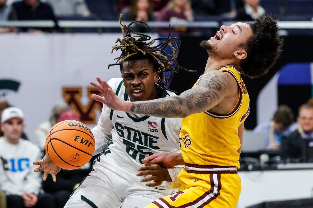 Michigan State forward Coen Carr (55) dribbles against Minnesota guard Braeden Carrington (4) during the first half of Second Round of Big Ten tournament at Target Center in Minneapolis, Minn. on Thursday, March 14, 2024.