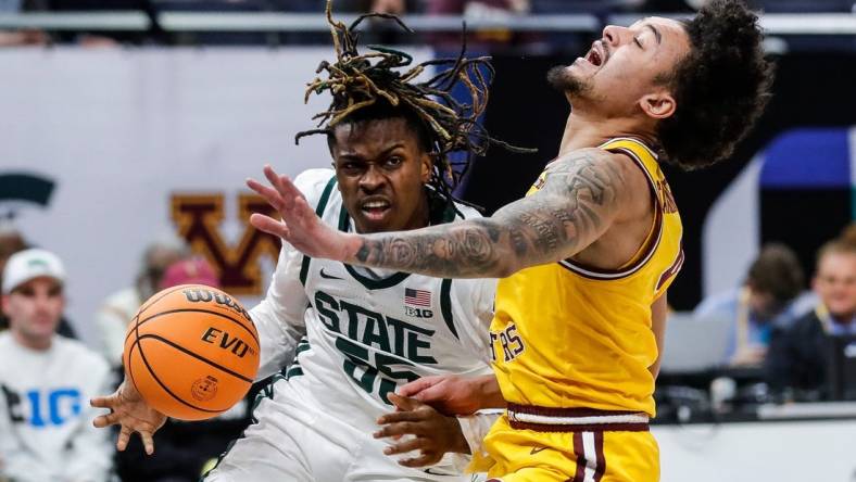 Michigan State forward Coen Carr (55) dribbles against Minnesota guard Braeden Carrington (4) during the first half of Second Round of Big Ten tournament at Target Center in Minneapolis, Minn. on Thursday, March 14, 2024.