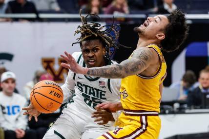 Michigan State forward Coen Carr (55) dribbles against Minnesota guard Braeden Carrington (4) during the first half of Second Round of Big Ten tournament at Target Center in Minneapolis, Minn. on Thursday, March 14, 2024.