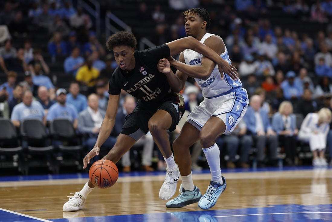 Mar 14, 2024; Washington, D.C., USA; Florida State forward Baba Miller (11) drives to the basket as North Carolina forward Harrison Ingram (55) defends in the first half at Capital One Arena. Mandatory Credit: Geoff Burke-USA TODAY Sports