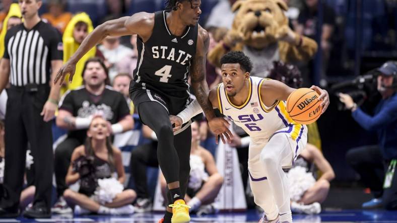 Mar 14, 2024; Nashville, TN, USA; LSU Tigers guard Jordan Wright (6) dribbles as Mississippi State Bulldogs forward Cameron Matthews (4) guards during the first half at Bridgestone Arena. Mandatory Credit: Steve Roberts-USA TODAY Sports