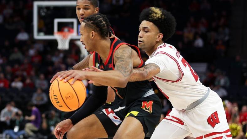 Mar 14, 2024; Minneapolis, MN, USA; Maryland Terrapins guard Jahmir Young (1) dribbles as Wisconsin Badgers guard Chucky Hepburn (23) defends during the first half at Target Center. Mandatory Credit: Matt Krohn-USA TODAY Sports