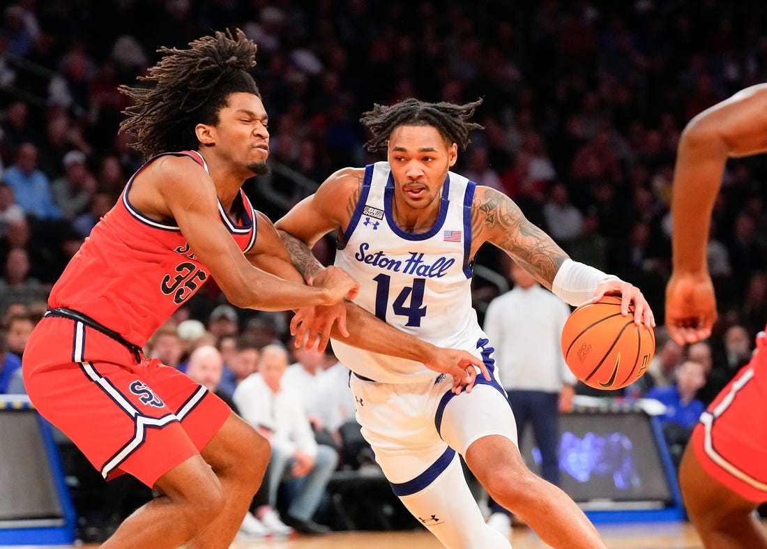 Mar 14, 2024; New York City, NY, USA;  Seton Hall Pirates guard Dre Davis (14) drives on St. John's Red Storm forward Glenn Taylor Jr. (35) during the first half at Madison Square Garden. Mandatory Credit: Robert Deutsch-USA TODAY Sports