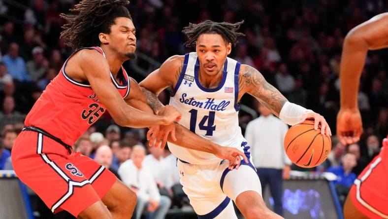 Mar 14, 2024; New York City, NY, USA;  Seton Hall Pirates guard Dre Davis (14) drives on St. John's Red Storm forward Glenn Taylor Jr. (35) during the first half at Madison Square Garden. Mandatory Credit: Robert Deutsch-USA TODAY Sports